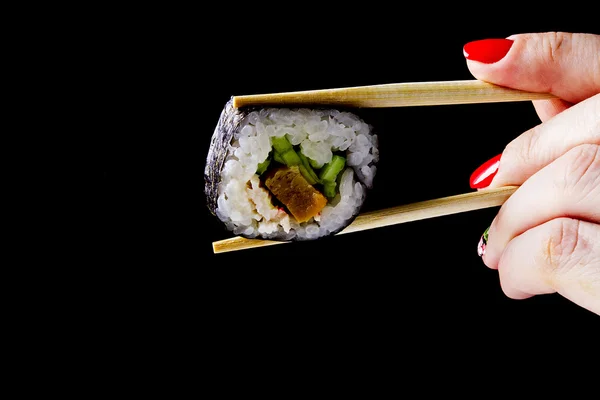 Sushi in wooden chopsticks — Stock Photo, Image