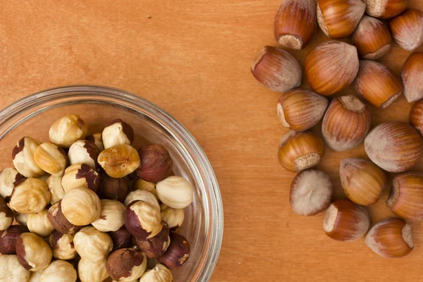 Hazelnuts - a wood nut in the shell on a wooden table surface — Stock Photo, Image