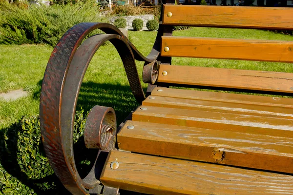 Gesmede metalen armleuningen met houten bankje — Stockfoto