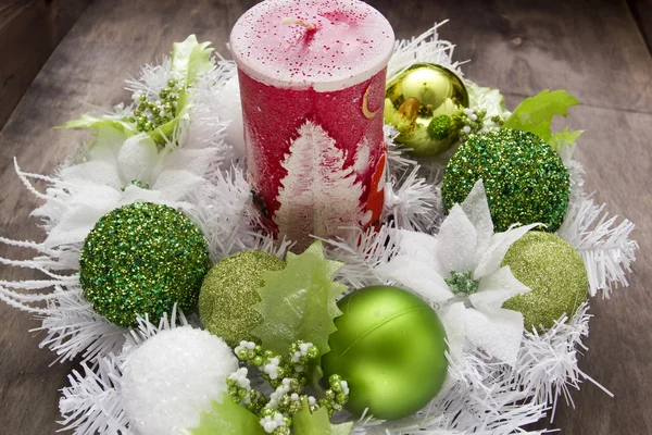 Big Christmas candle and festive wreath — Stock Photo, Image