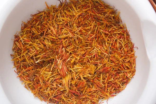 Inflorescence of saffron in a ceramic mortar — Stock Photo, Image