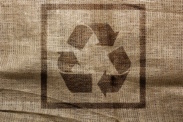 Stamp on sackcloth industrial recycling symbol — Stock Photo, Image