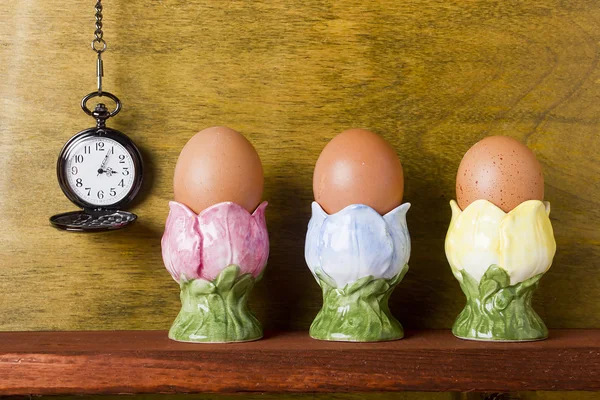 Eggs in the stands and pocket watches — Stock Photo, Image