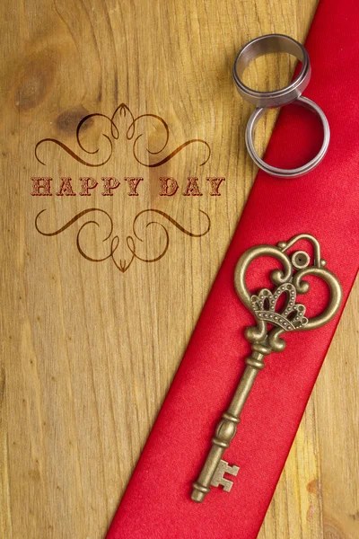 Key and wedding rings — Stock Photo, Image