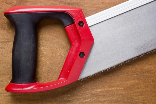 Hand saw with a red handle — Stock Photo, Image