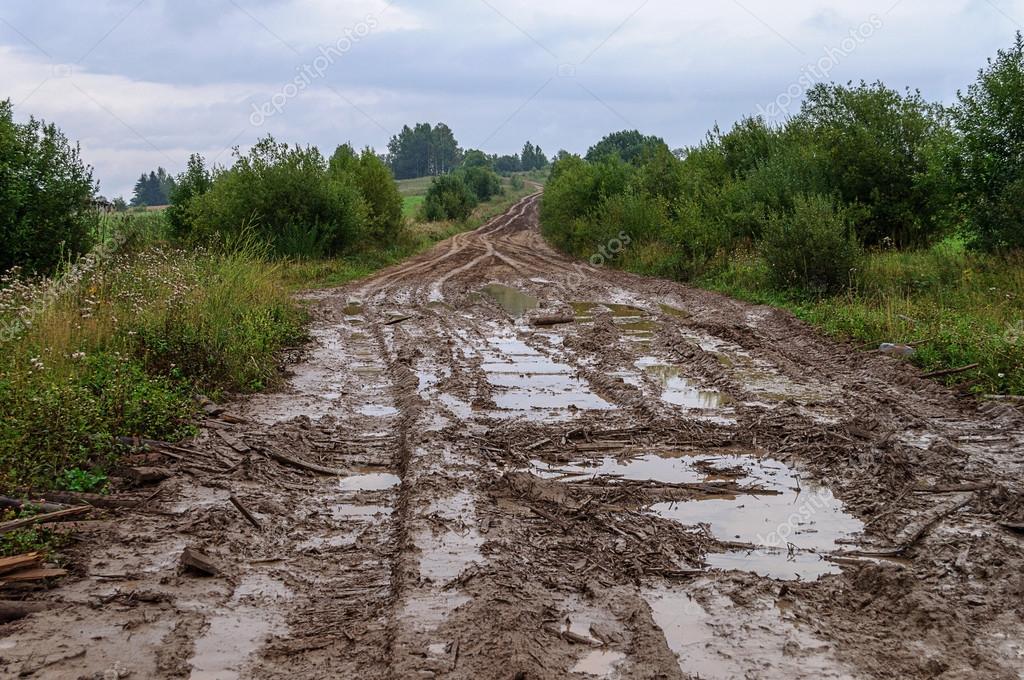 Muddy dirt road in a hilly countryside Stock Photo by ©viknik 58618569