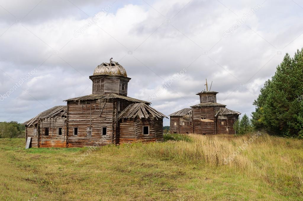 Two ancient destroyed wooden churchs in northern russian village