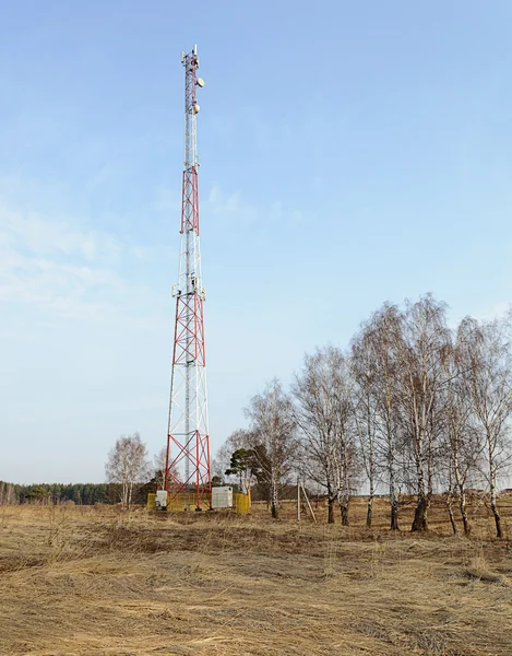 Country spring landscape with cellular tower — Stock Photo, Image