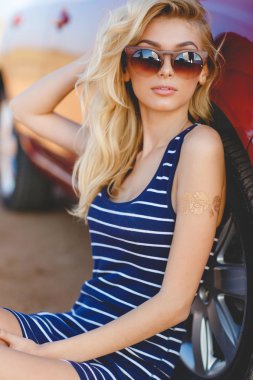 Beautiful young sexy woman near car outdoor