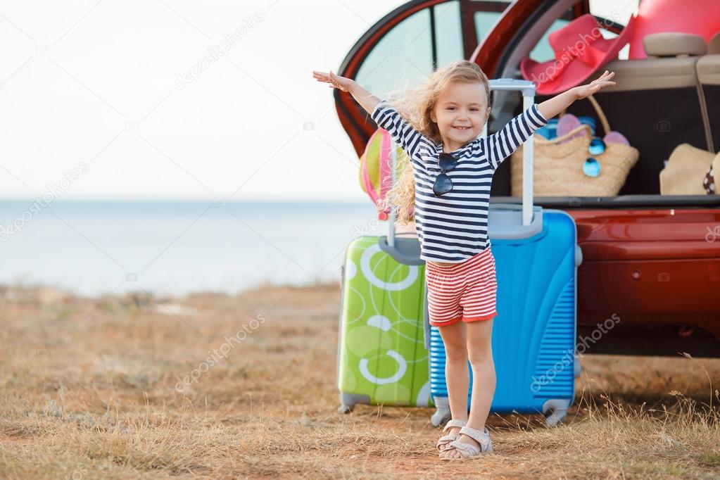 A little girl goes on a journey on a red car