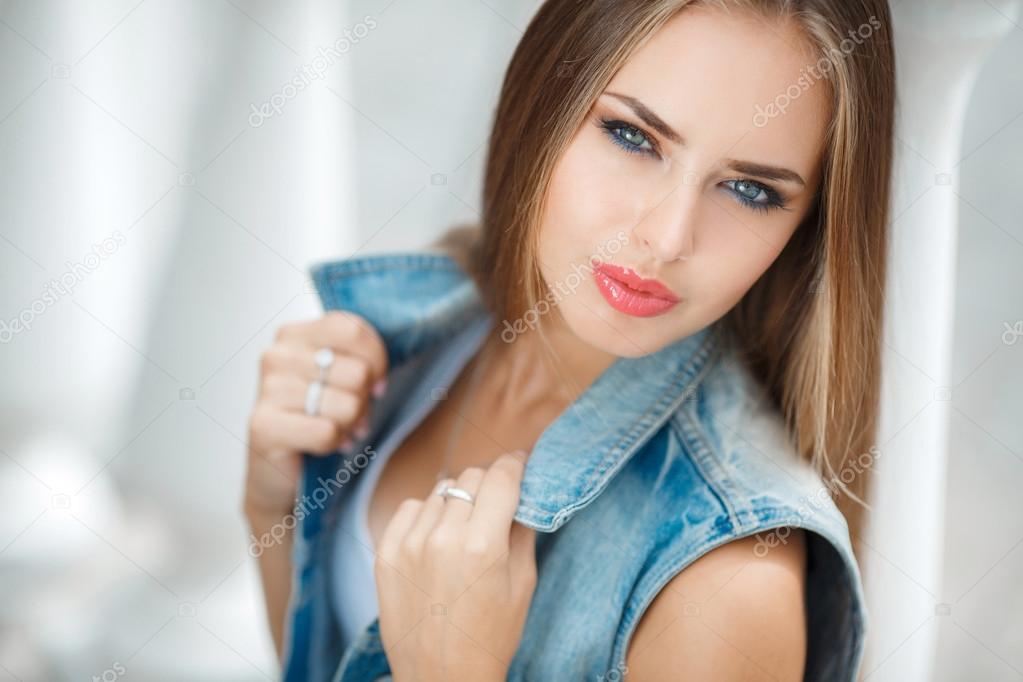 Portrait of young beautiful brunette in the city background