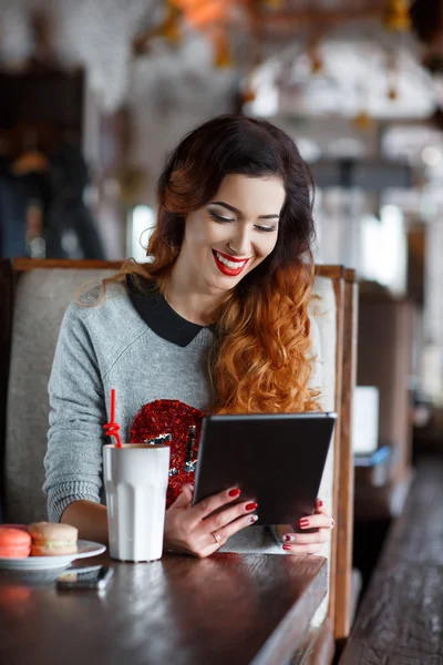 Mujer joven atractiva con tableta en la cafetería — Foto de Stock