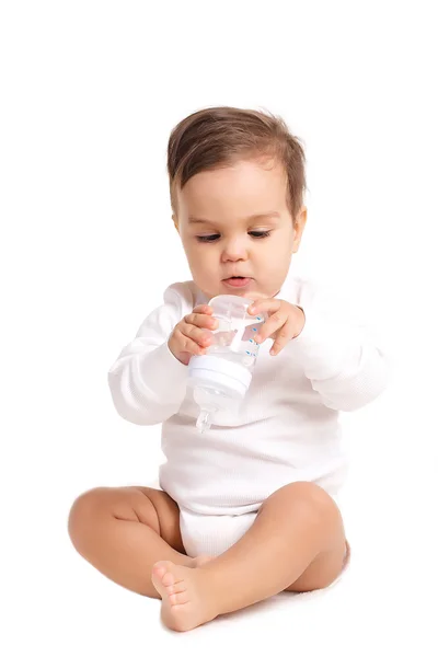 Sweet baby holding bottle and drinking water — Stock Photo, Image