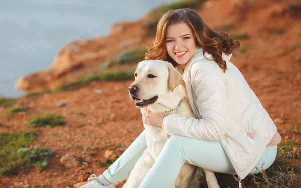 Vacker flicka med hennes hund nära havet — Stockfoto