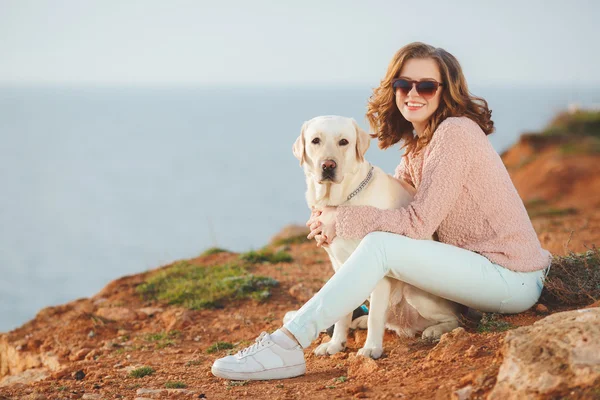 Beautiful girl with her dog near sea — Stock Photo, Image