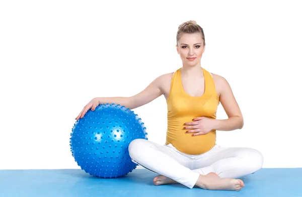 妊娠中の女性はボールで体操をする — ストック写真