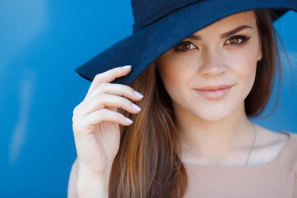 Closeup portrait of a beautiful young woman with hat outdoor looking at camera — Stock Photo, Image