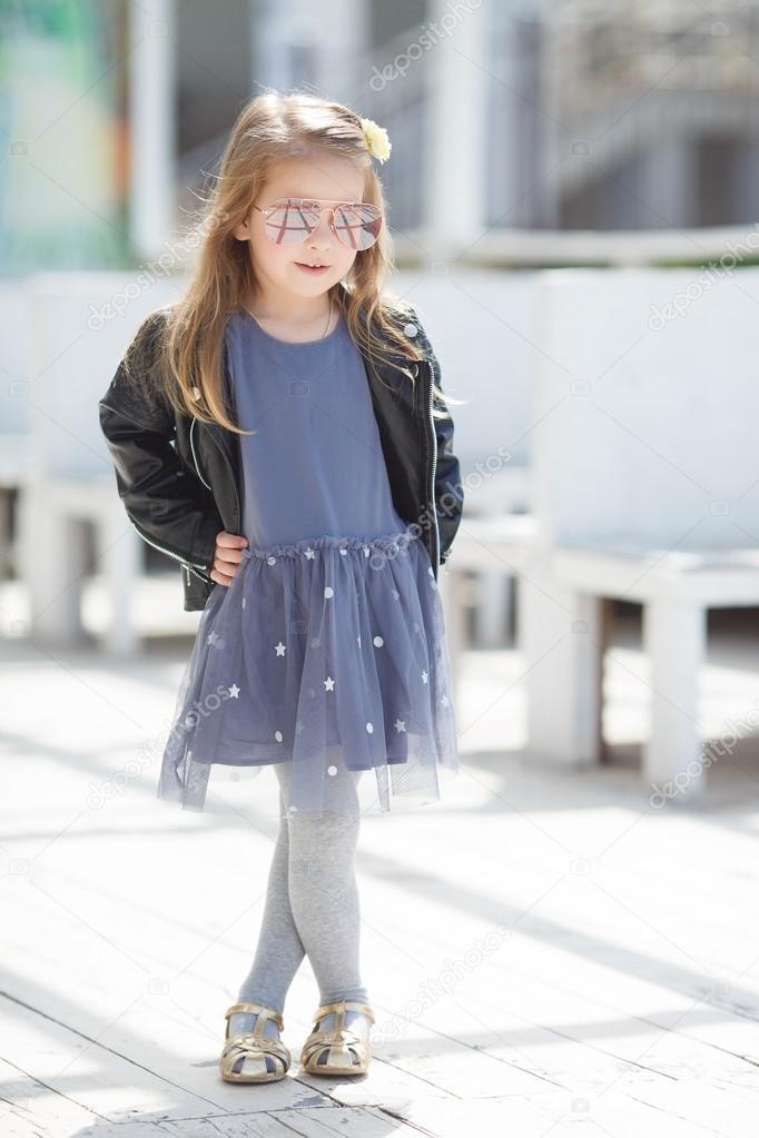 Portrait of an adorable toddler girl wearing fashion clothes. Stock Photo  by ©golyak 107346400