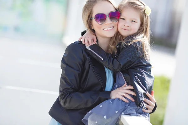 Retrato urbano de madre feliz con hija pequeña — Foto de Stock