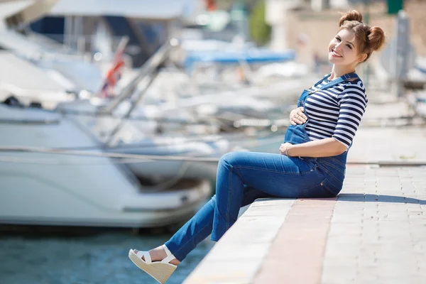 Беременная женщина отдыхает на набережной — стоковое фото