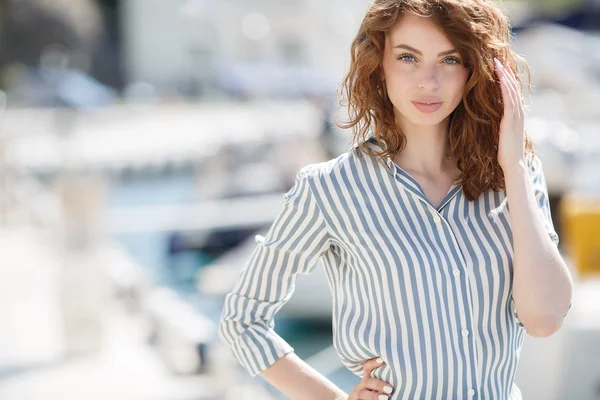 Beautiful girl on the pier next to the yacht club — Stock Photo, Image