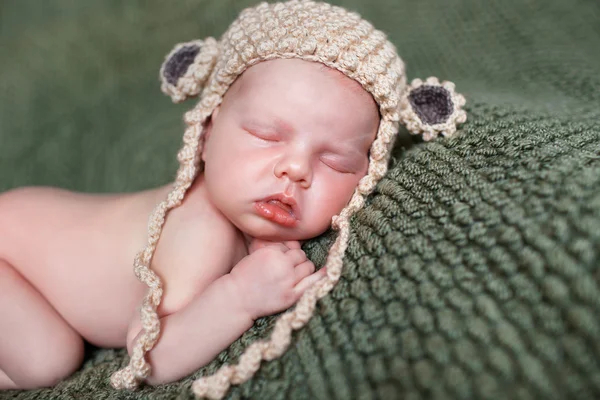 Sleeping newborn baby in a knitted blanket