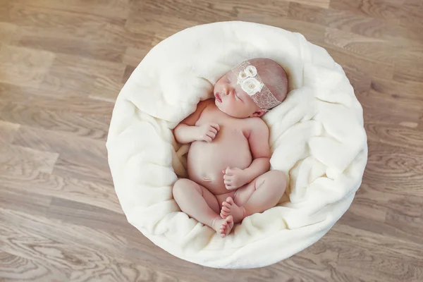 Das neugeborene Kind schläft auf einer weißen Decke — Stockfoto