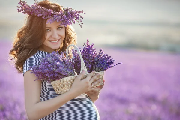 Gravid kvinna i turkos klänning på lavendel fält — Stockfoto