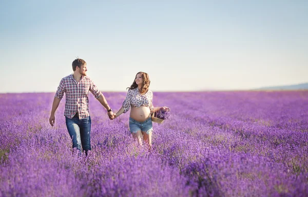 Happy young couple in a field of blooming lavender