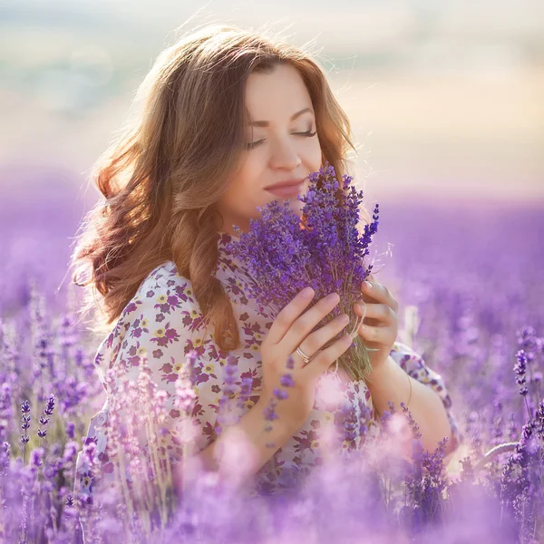 Beautiful woman in a lavender field — Stock Photo, Image
