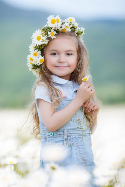 Liten flicka i en krans av vita prästkragar — Stockfoto