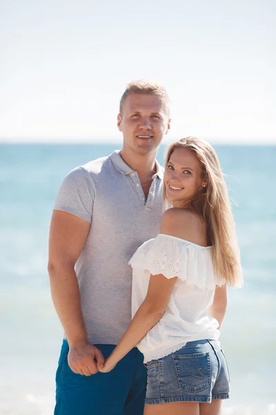 Unga älskande par på stranden nära havet — Stockfoto