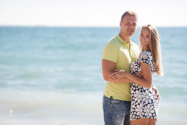 Unga älskande par på stranden nära havet — Stockfoto