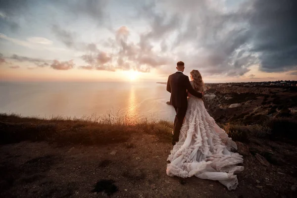 Portrait d'une mariée heureuse en robe de luxe et marié, mariage au coucher du soleil — Photo