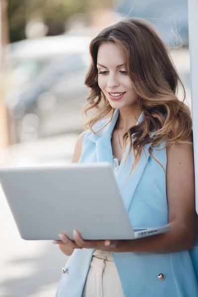 Retrato de uma jovem mulher com laptop ao ar livre — Fotografia de Stock
