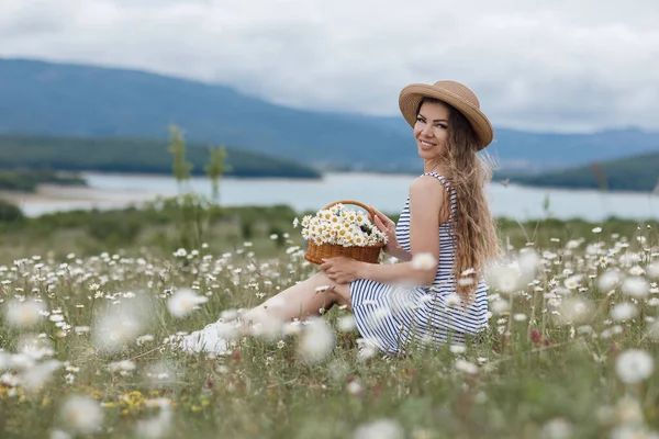 Närbild porträtt av en ung vacker kvinna i en kamomill fält — Stockfoto