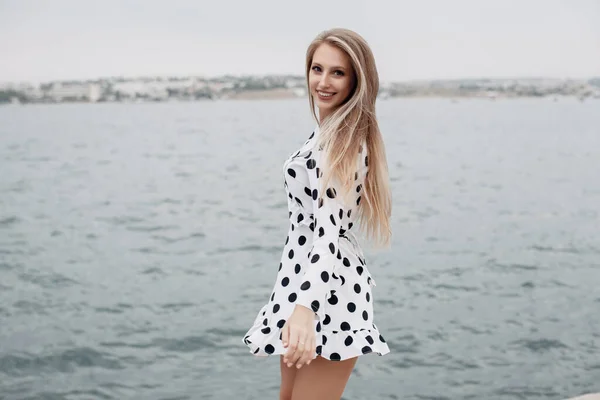 Young happy woman in sunny dress outdoors — Stock Photo, Image