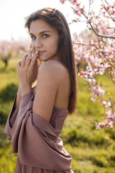 Beautiful young woman outdoor in bloom field Royalty Free Stock Images