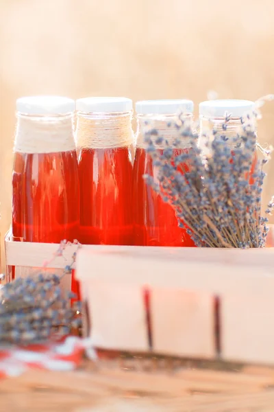 Juice, bär och lavendel i en halm korg. — Stockfoto