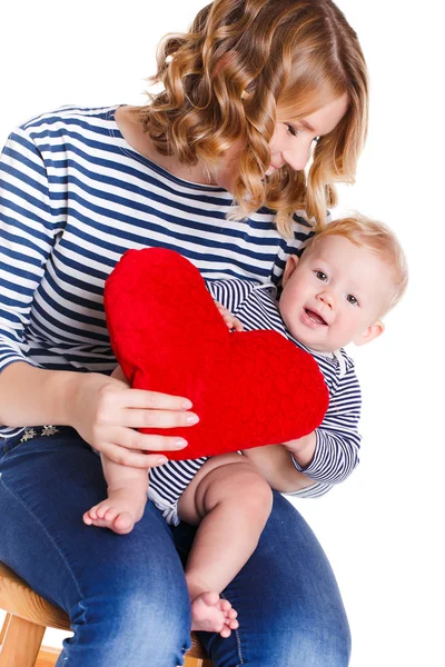 Happy mother and her child holding a red heart — Stock Photo, Image