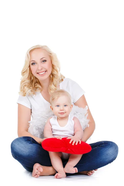 Happy mother and her child holding a red heart — Stock Photo, Image