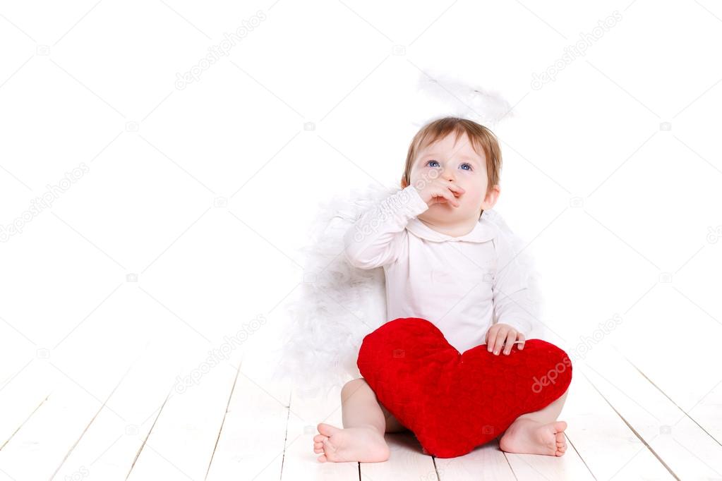 Little angel with red heart isolated on white.