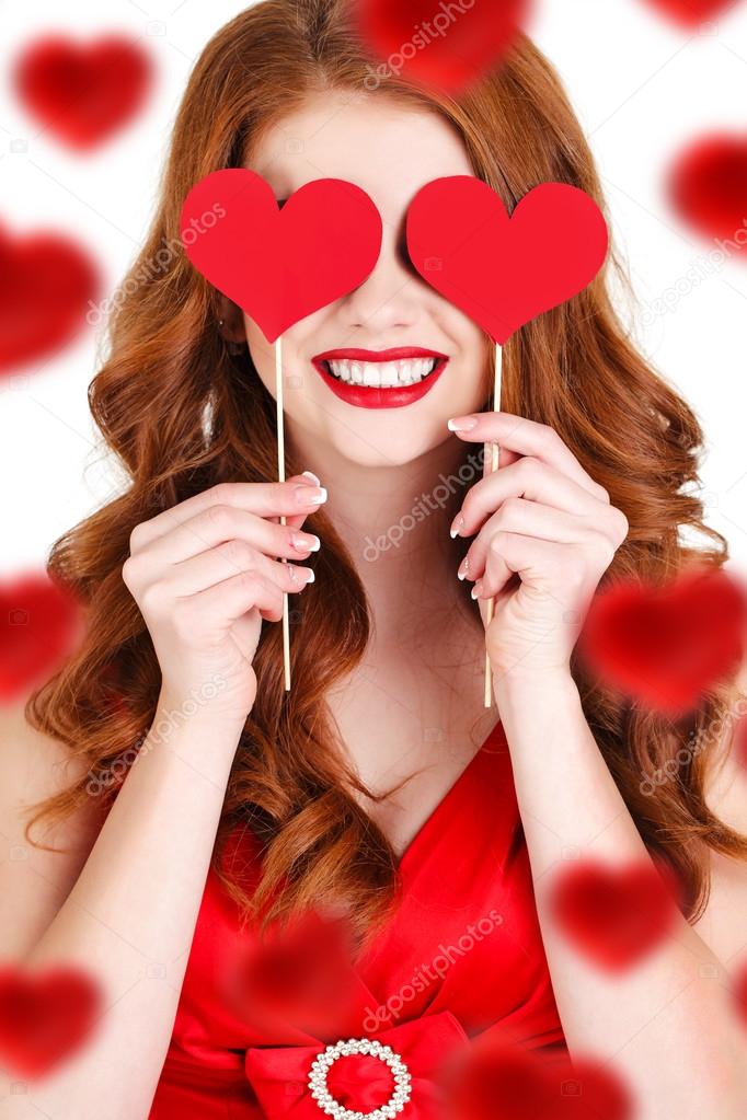 Beautiful girl in a Valentine's Day with a heart on a stick.
