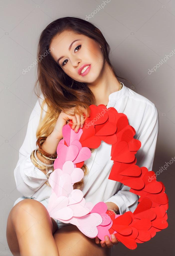 Beautiful woman with symbol Valentine's day in his hands.