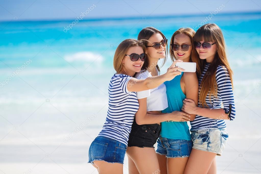 Beautiful girls are photographed on a tropical resort on the background of the beach and ocean.