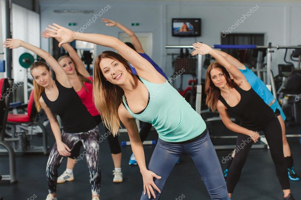 Group of young beautiful women conducts training on fitness in the