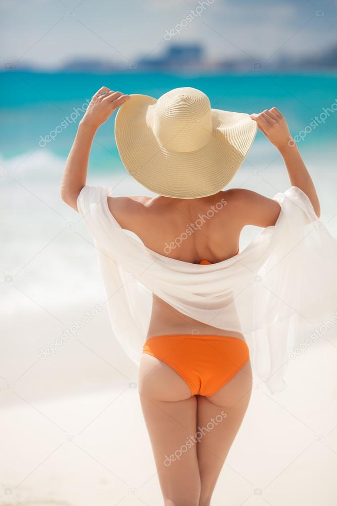 Bronze Tan Woman Sunbathing At Tropical Beach