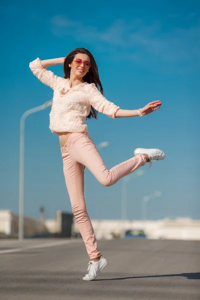 Young sexy girl in a good mood on the street in the city — Stock Photo, Image