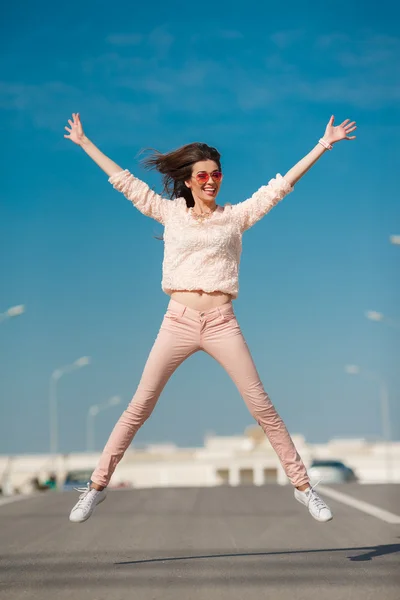 Young sexy girl in a good mood on the street in the city — Stock Photo, Image