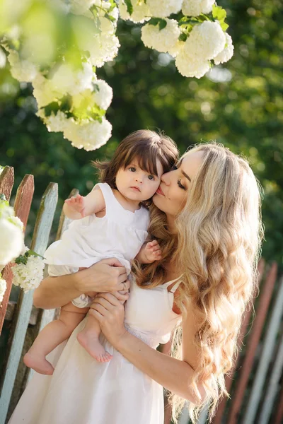 Portrait of happy woman with a small daughter in the village in the spring — Stock Photo, Image